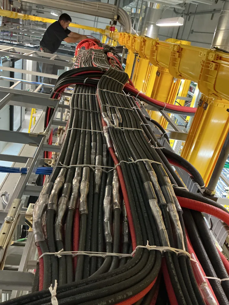 New Phase technician working on DC power cable runs at an Arizona facility