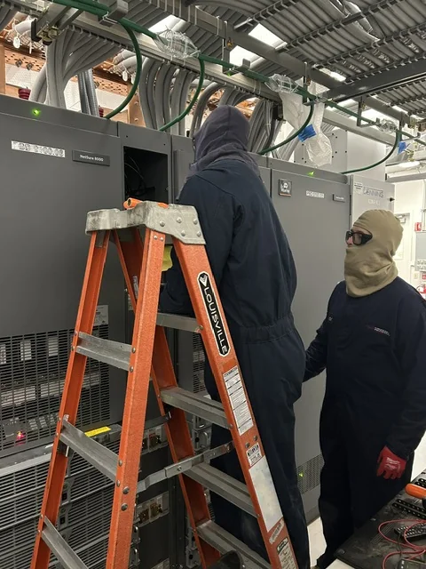 New Phase technicians servicing a Vertiv NetSure DC power plant at an Arizona facility